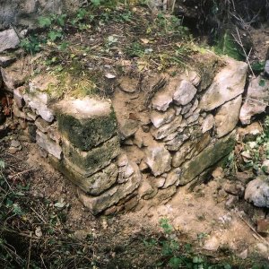 Obr. 63: Veveří - hrad 2002. Průzkum a dokumentace reliktů zdiva mezi věžemi hranolovou a prachovou. Od 80. let minulého stol. zůstaly odkryty relikty kamenného středověkého zdiva s bránou na vnější straně současné JV hradby. Jejich zbytky byly začištěny, zdokumentovány a přesně zaměřeny (foto P. Vitula).