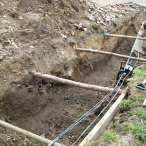 Obr. 115: Veveří – hrad 2015. Vodovod. Profil výkopu pro vodovodní potrubí s novověkým souvrstvím v prostoru středního hradu – pohled od SV (foto P. Vitula).