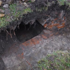 Obr. 207: Veveří – hrad 2021. Páteřní rozvody elektřiny. Otevřený novověký odpadní kanál ve svahu nad jižní bránou – pohled od SZ (foto P. Vitula).
